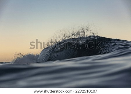 abstract wave breaking with a sunrise background