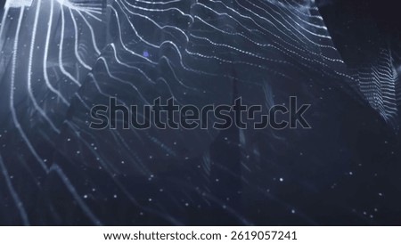 Abstract wavy surface gently moving with particles on dark background. Action