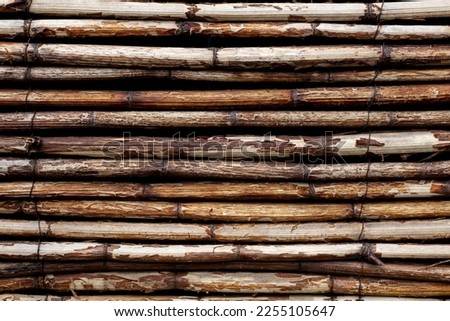 Abstract weathered brown wooden textured background. Handmade line pattern made from old brown willow twigs. Copy space for your text or decoration. Wooden materials theme.