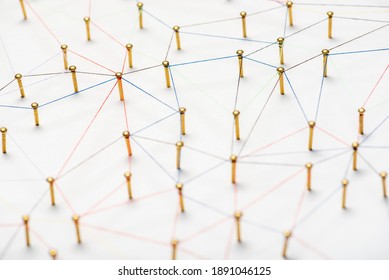abstract web line connection of color yarn from nail node to node on white background , networking concept