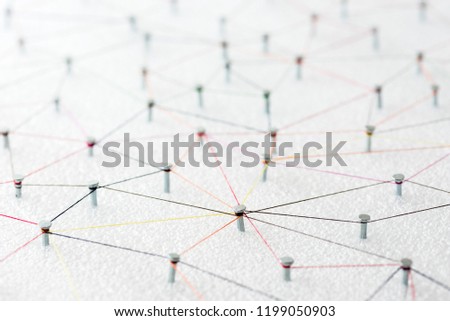 abstract web line connection of color yarn from nail node to node on white background , networking concept