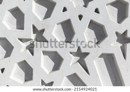 Abstract white Arabic pattern, close up background texture. Mosque wall decoration