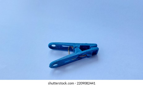 abstract. white background clothespins in blue. clothespins made of plastic