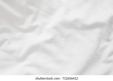 Abstract White Bedding Sheets Or Blanket Background And Texture With Copy-space :Creased Or Wrinkled White Fabric :Soft Focus