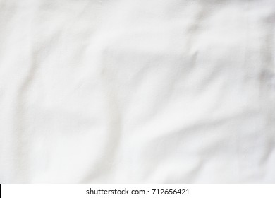 Abstract White Bedding Sheets Or Blanket Background And Texture With Copy-space :Creased Or Wrinkled White Fabric :Soft Focus