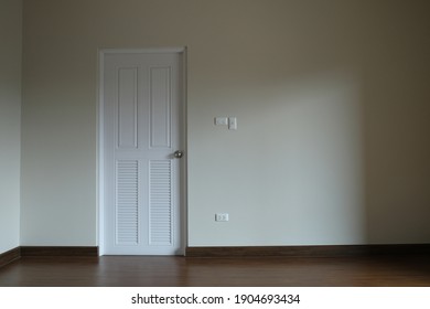 Abstract White Door Close In Dark Light. Sad And Alone Emotion In Empty House. Vacancy Property White Wall Background. 