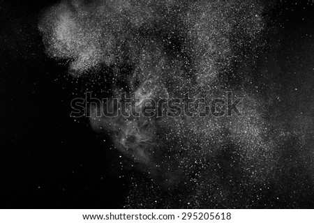abstract white dust explosion  on black background. 