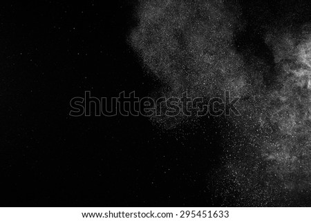 abstract white dust explosion  on black background. 
