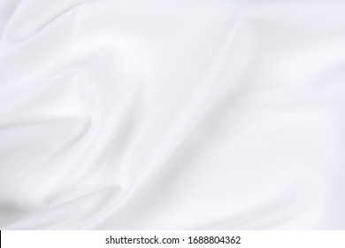 Abstract White Fabric Texture Background. Cloth Soft Wave. Creases Of Satin, Silk, And Cotton.