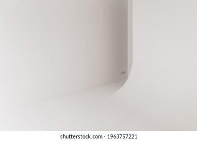 Abstract white photo studio interior background, empty blank cyclorama structure with a smooth transition between horizontal and vertical planes