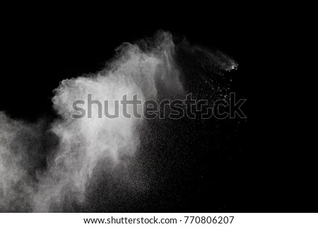 Abstract white powder explosion on white background. White dust splatter in dark background. White particles splash in the air. May use for abstract background.