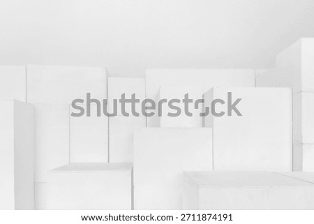 Abstract white stepped multilevel background. Snow-white cubes and parallelepipeds, a geometric maze on a white background, a sense of spatial depth.