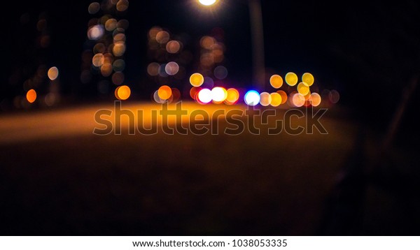 Abstract wide angle background photograph of out\
of focus lights from an accident scene with fire trucks, ambulance\
and cop cars and high rise buildings beyond on lake shore drive in\
Chicago.