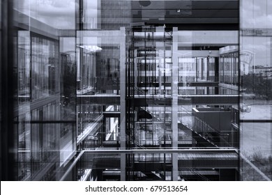 Abstract Window Reflections In Morden Office Building. Contemporary Corporate Business Architecture. Black And White, Blue Toned Image.