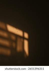 Abstract window shadow falls on a plain wall, captured in soft evening light. Minimalist and poetic moment.