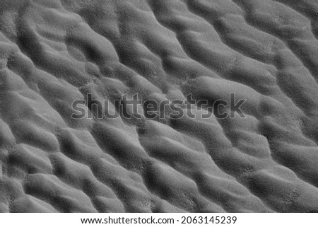 Abstract of wind-shaped patterns in sand dunes