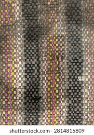 Abstract woven textile background featuring a handwoven grid pattern with textured fabric fibers in muted gray, black, beige, pastel pink, yellow, and blue tones. Close-up view of a contemporary rug or fabric surface with intricate checkered design, soft wool texture, and artisanal craftsmanship. Perfect for backgrounds, interior design concepts, fashion materials, textile patterns, and modern decorative applications.