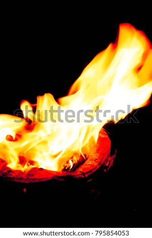 Abstract yellow fire on stove with black isolated background. 