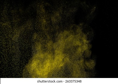  Abstract Yellow And Gold Powder Explosion On Black Background.