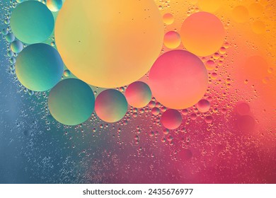 Abstract yellow, green, pink and blue colorful background with oil on water surface. Oil drops in water abstract psychedelic, abstract image.