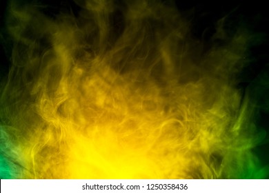 abstract yellow and green smoke on black background