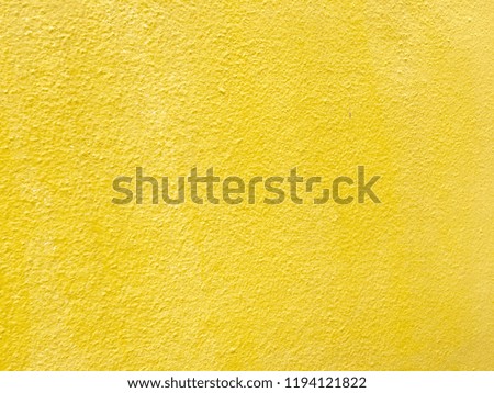 Abstract yellow paint cement wall background