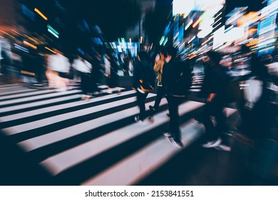 Abstract Zoom Blur Of Pedestrian Crossing Or Crosswalk In Shinjuku City During Evening Rush Hour With Many People Waiting To Cross. Urban Nightlife And Commuter Rushing Concept In Tokyo, Japan.