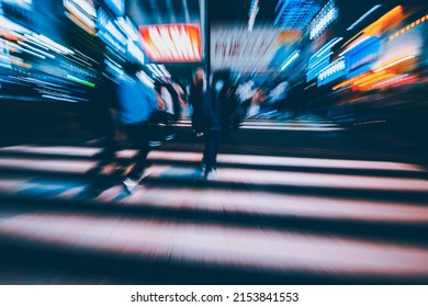 Abstract Zoom Blur Of Pedestrian Crossing Or Crosswalk In Shinjuku City During Evening Rush Hour With Many People Waiting To Cross. Urban Nightlife And Commuter Rushing Concept In Tokyo, Japan.