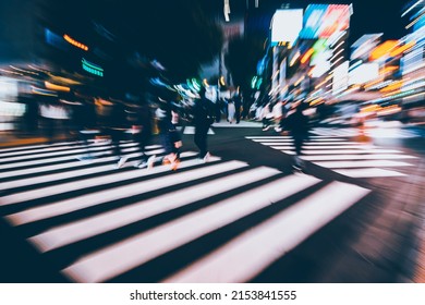 Abstract Zoom Blur Of Pedestrian Crossing Or Crosswalk In Shinjuku City During Evening Rush Hour With Many People Waiting To Cross. Urban Nightlife And Commuter Rushing Concept In Tokyo, Japan.