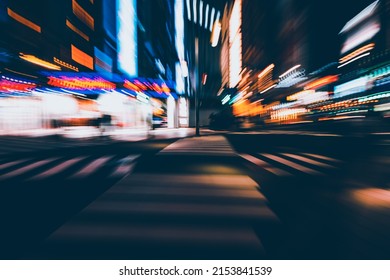 Abstract Zoom Blur of Scramble Crossing in Shinjuku City of Tokyo, Japan during the night with light from billboard and neon sign of business. Nightlife and modern urban lifestyle concept.