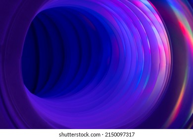 Abstraction, corrugated pipe with circles of rainbow light