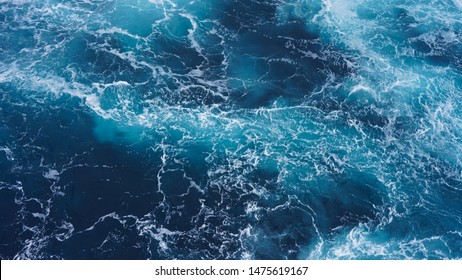   Abstraction of sea foam in the ocean. Dark water, storm waves