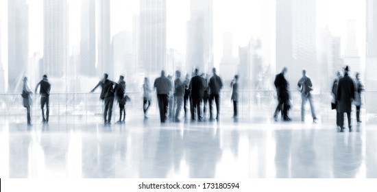 abstrakt image of people in the lobby of a modern business center with a blurred background and blue tonality