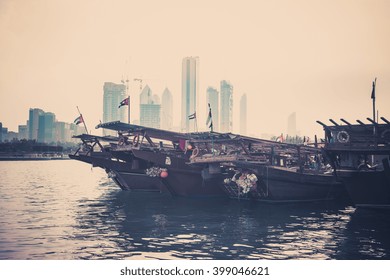 Abu Dhabi buildings skyline with old fishing boats on the front. Filtered shot - Powered by Shutterstock