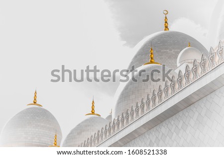 Abu Dhabi grand mosque in white with the golden howl moon on the dome and a white background, creative abstract photography 
