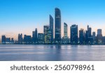 "Abu Dhabi Skyline: Night-to-Day Transition with Water Reflection from the Breakwater"