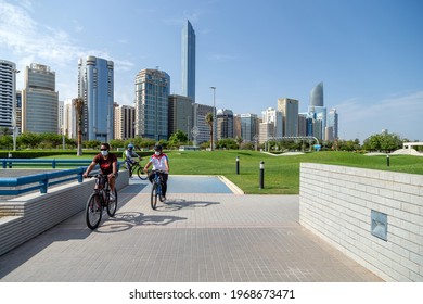 ABU DHABI, UAE - APRIL 30, 2021: Group of men riding bikes on Abu Dhabi Corniche in the morning. Active healthy lifestyle.