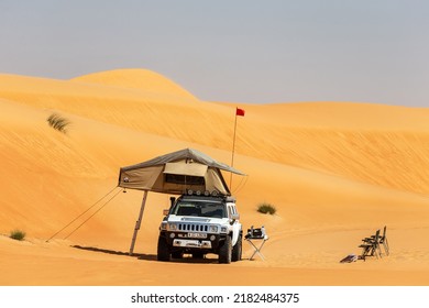 Abu Dhabi, UAE - February 27, 2021: Camping In Liwa Desert, Car With The Tent On The Roof. High Quality Photo.