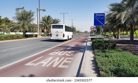 ABU DHABI, UAE - FEBRUARY 9, 2019: Bus Driving Away From The Bus Stop, Also Showing Bus Lane On The Road