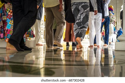 ABU DHABI, UAE - MAR 21 2017: Visitors Inside Of The Sheikh Zayed Mosque In Abu Dhabi Walking Barefoot. Close Up.