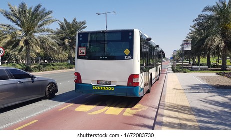 ABU DHABI, UAE - MARCH 5, 2020: Bus Driving Away From The Bus Stop, Also Showing Bus Lane On The Road