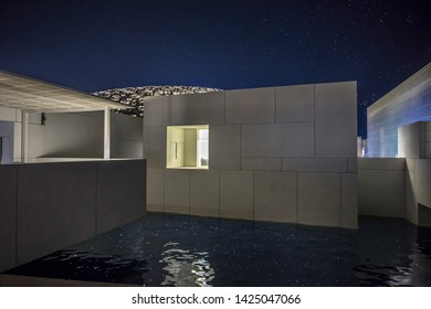 ABU DHABI, United Arab Emirates. UAE - MAY 9, 2019: Louvre Abu Dhabi The Famous Museum At Night Time With Stars And Moon In The Sky