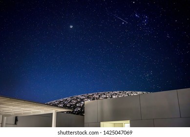 ABU DHABI, United Arab Emirates. UAE - MAY 9, 2019: Louvre Abu Dhabi The Famous Museum At Night Time With Stars And Moon In The Sky