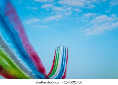 Abu Dhabi, United Arab Emirates - December 2, 2019: Jet Planes Leaving Colorful Trails On The Sky During An Airshow In The UAE