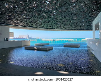 Abu Dhabi, United Arab Emirates - January 12, 2021: Louvre museum in Abu Dhabi interior and dome with with characteristic architecture and seaside view in the capital city of United Arab Emirates