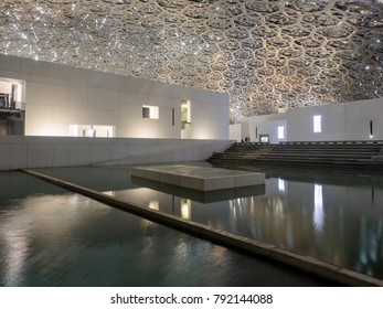 Abu Dhabi, United Arab Emirates - December 20, 2017: The Louvre Museum With Modern Design Exterior Luminated At Night 