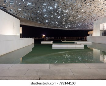 Abu Dhabi, United Arab Emirates - December 20, 2017: The Louvre Museum With Modern Design Exterior Luminated At Night 