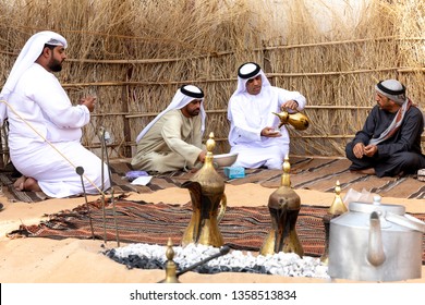 Abu Dhabi/UAE - January 12 2019: Arabic Men Gather Together And Drink Coffee Seating In Traditional Bedouin Tent. Arabic Hospitality Concept