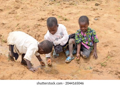 Abuja Nigeria - August 02, 2021:  African Children Playing With Sand On A Sunny Day. Fun Time With Third World Kids