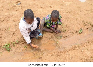 Abuja Nigeria - August 02, 2021:  African Children Playing with Sand on a Sunny Day. Fun Time with Third World Kids